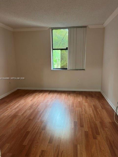An empty room features light-colored walls, wood-look flooring, and a window with vertical blinds — 14321 N Kendall Dr # 403F, Miami FL 33186, MIAMI, FL