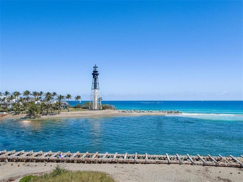 A tall lighthouse stands on a sandy beach beside a blue ocean and wooden pier — 3421 Dover Road, Pompano Beach FL 33062, POMPANO BEACH, FL