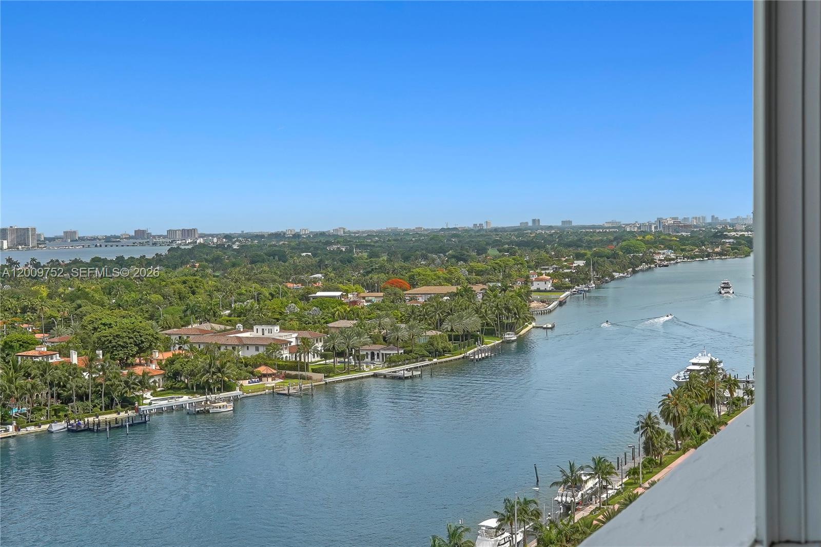An elevated view shows a waterway winding through a lush, tropical residential neighborhood — 4747 Collins Ave # 1503, Miami Beach FL 33140, MIAMI BEACH, FL