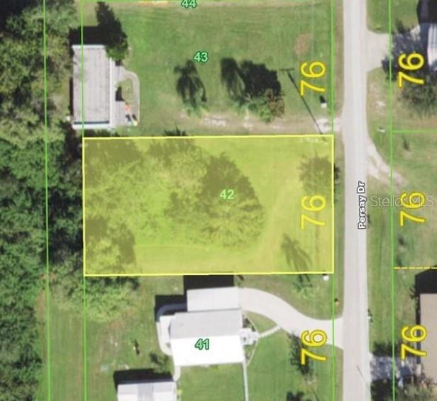 This is an aerial map showing a vacant residential lot highlighted in yellow — 1319 PERSAY DRIVE, PUNTA GORDA, FL