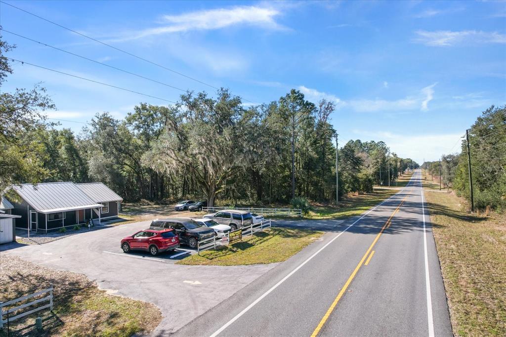An aerial view shows a small building with a metal roof and a parking lot — 7652 W DUNNELLON ROAD, DUNNELLON, FL