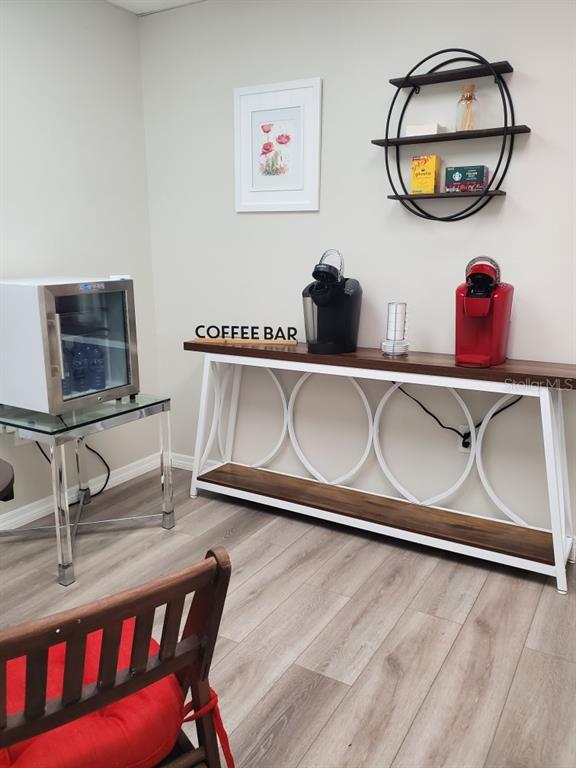 A coffee bar area features a console table, two coffee makers, and a small refrigerator — 2730 WORTH AVENUE UNIT 8, ENGLEWOOD, FL
