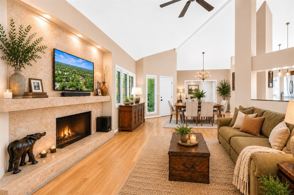A living room features a stone fireplace, hardwood floors, and an adjacent dining area — 10495 LONGWOOD DRIVE, SEMINOLE, FL
