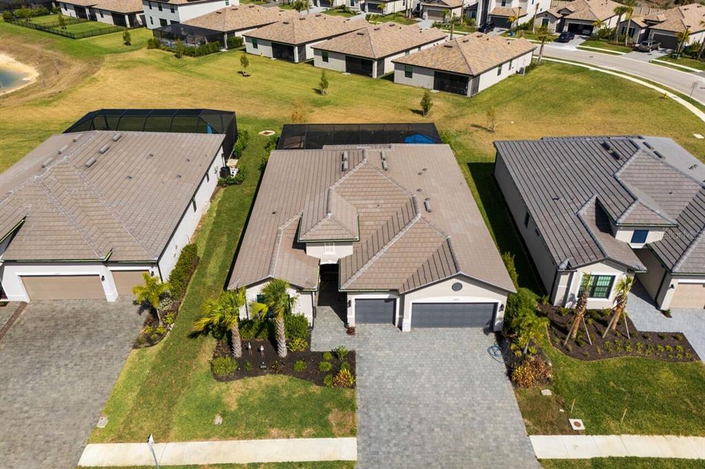 An aerial view of a suburban house with a tiled roof and paved driveway — 10903 TIMBER CREEK DRIVE, FORT MYERS, FL