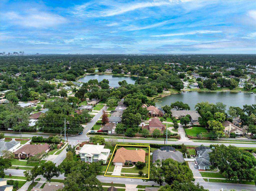 An aerial view shows a single-story house with a brown roof outlined in yellow — 4025 CONWAY PLACE CIRCLE, ORLANDO, FL