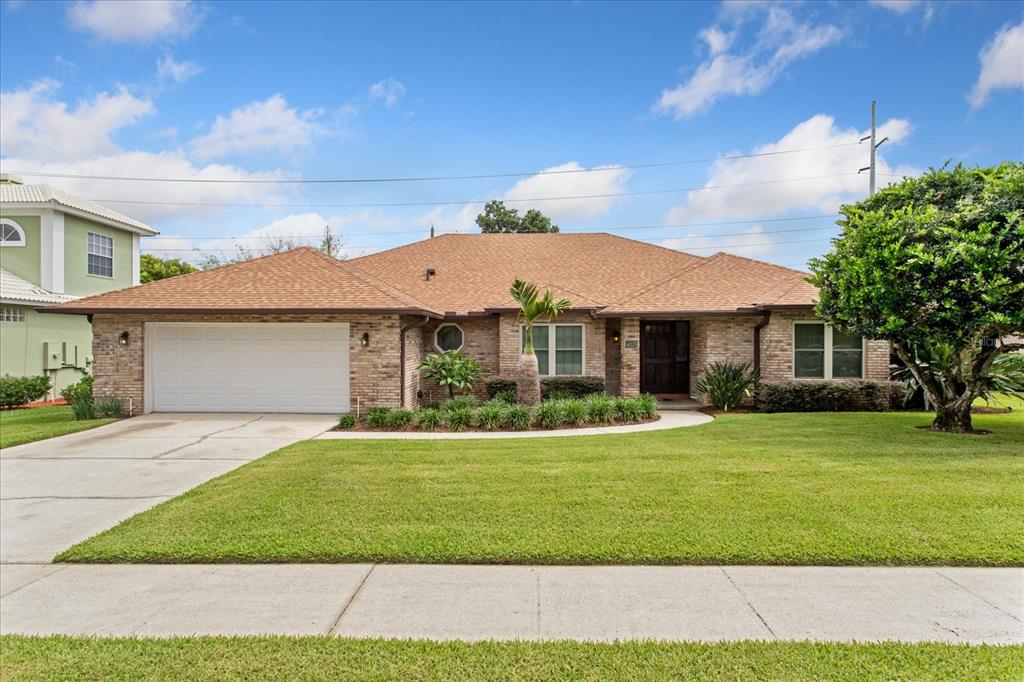 A single-story brick house with a two-car garage and a landscaped front lawn — 4025 CONWAY PLACE CIRCLE, ORLANDO, FL