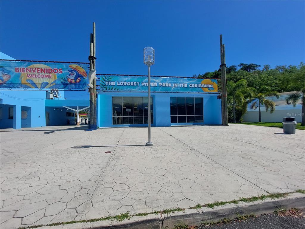 The exterior of a blue building features a sign identifying it as a water park — Bo Caín Alto LOCAL #2 SURF N' FUN WATER PARK, SAN GERMAN, PR