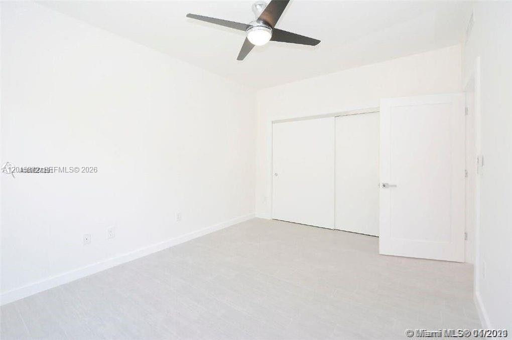 An empty bedroom features white walls, light-colored flooring, a ceiling fan, and a closet — 620 Michigan Ave # 7, Miami Beach FL 33139, MIAMI BEACH, FL