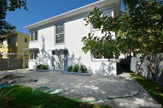 A two-story white house with a paved patio and a green hose in the yard — 620 Michigan Ave # 7, Miami Beach FL 33139, MIAMI BEACH, FL