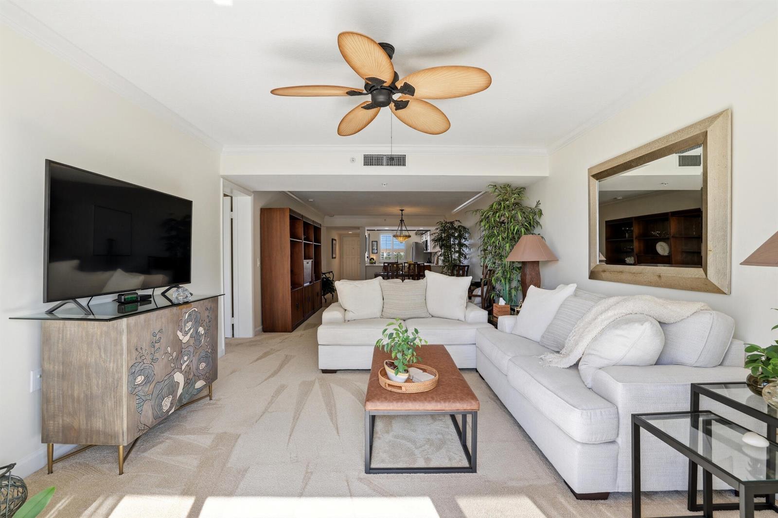 A living room features two white sofas, a coffee table, and a ceiling fan — 2101 Marina Isle Way # 404, Jupiter FL 33477, JUPITER, FL