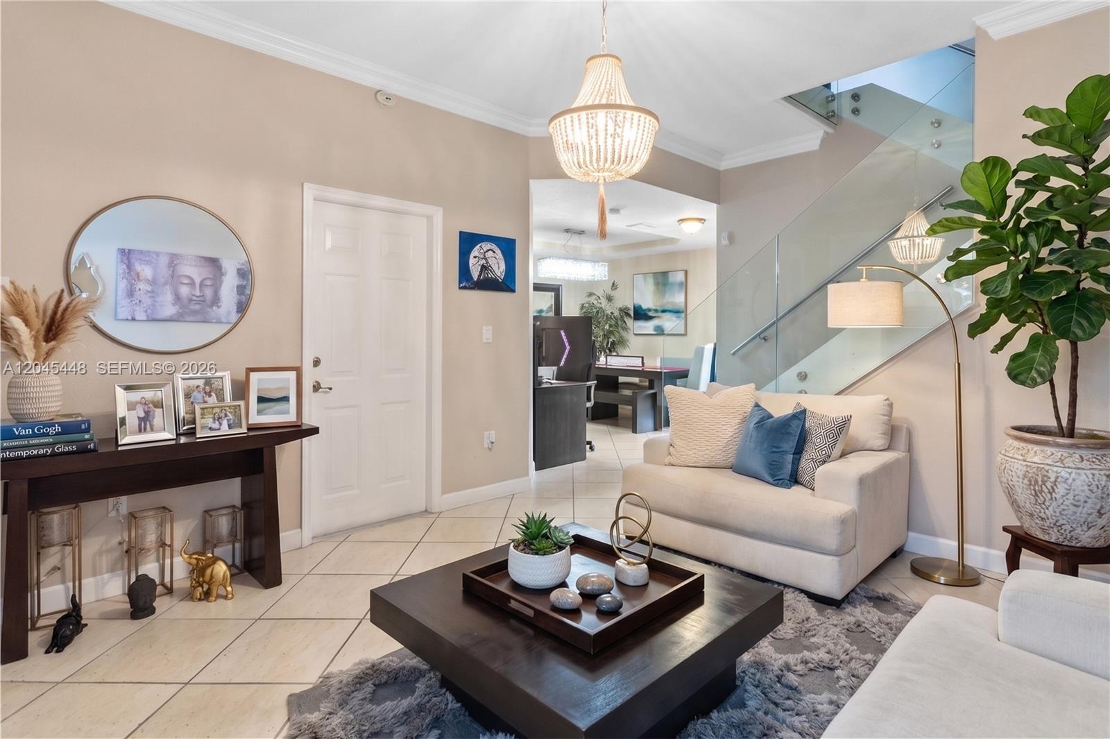 A living room features a beige sofa, a dark coffee table, and a glass staircase — 8133 SW 118th Ct # 8133, Miami FL 33183, MIAMI, FL