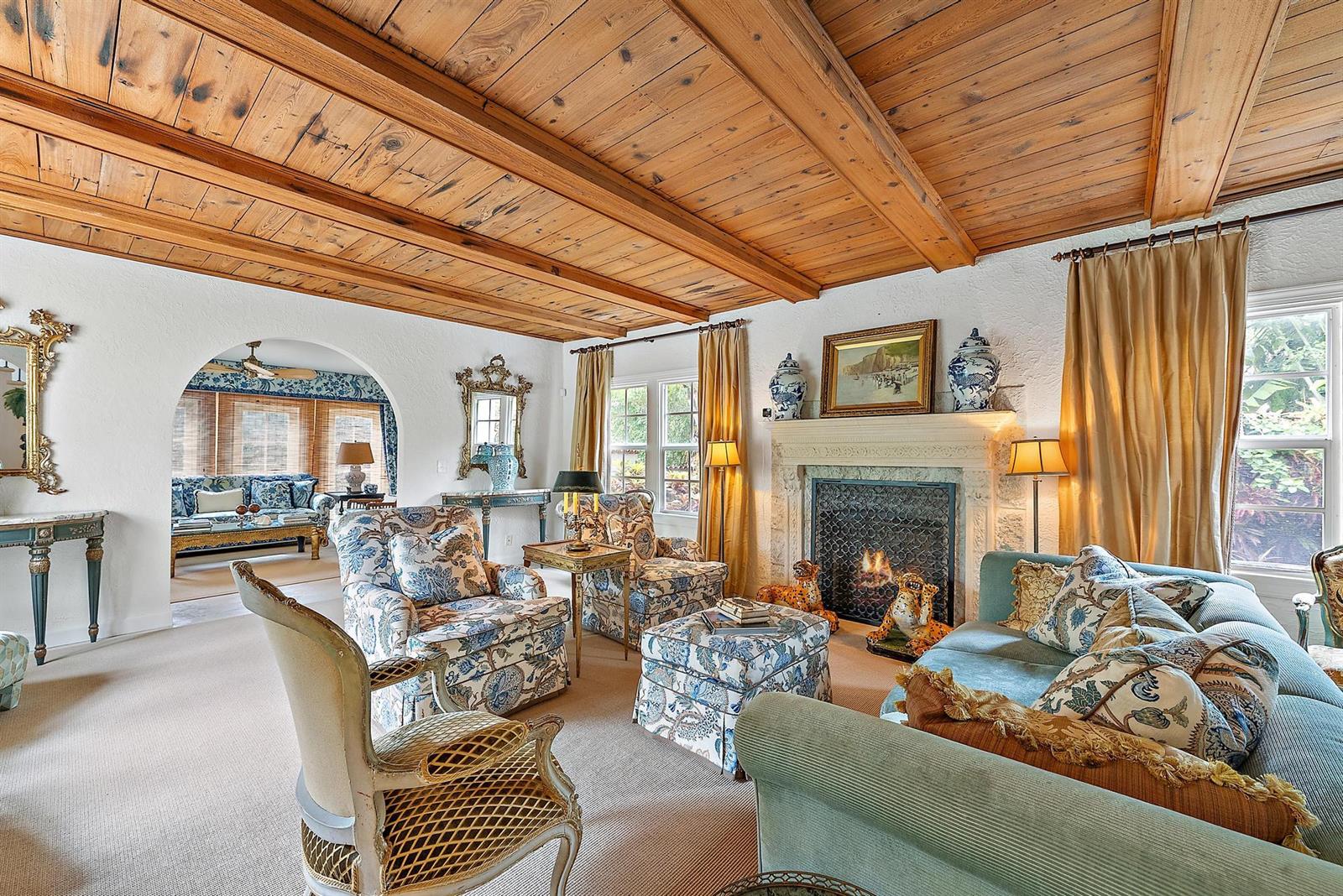 A living room features a wood-beamed ceiling, a stone fireplace, and floral upholstered furniture — 325 Seaspray Avenue, Palm Beach FL 33480, PALM BEACH, FL