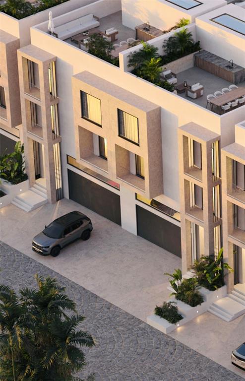 This architectural rendering shows the exterior of modern townhomes with rooftop terraces and garages — 6645 N OCEAN SHORE BOULEVARD UNIT 7A, PALM COAST, FL