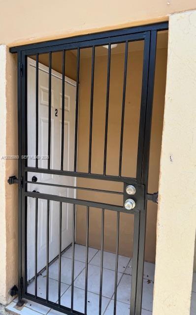 A black metal security gate stands in front of a white door marked with number two — 927 NW 7th Ct # 2, Miami FL 33136, MIAMI, FL