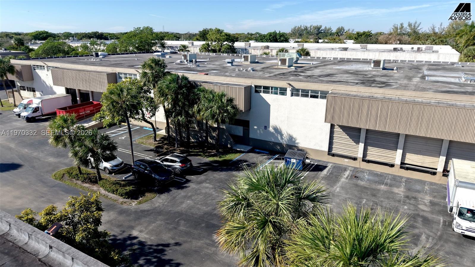 An aerial view shows a commercial warehouse building with loading docks and a parking lot — 5800 E Miami Lakes Dr E, Miami Lakes FL 33014, MIAMI LAKES, FL