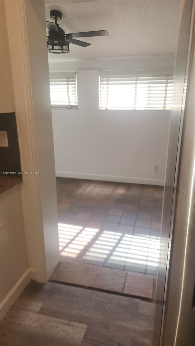 A view through a doorway shows a room with tiled floors and a ceiling fan — 2174 NE 182nd St, North Miami Beach FL 33162, NORTH MIAMI BEACH, FL