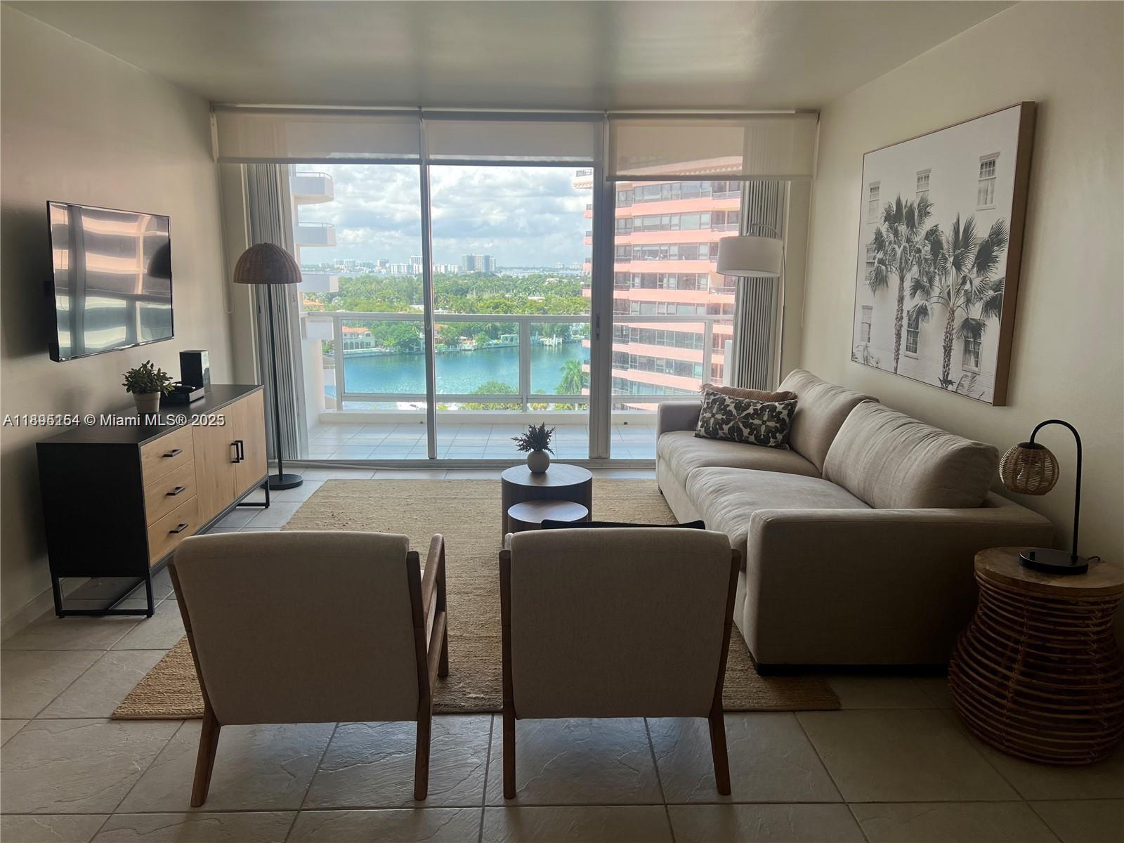 A living room features a sofa, two armchairs, a media console, and a balcony view — 5161 Collins Ave # 1211, Miami Beach FL 33140, MIAMI BEACH, FL