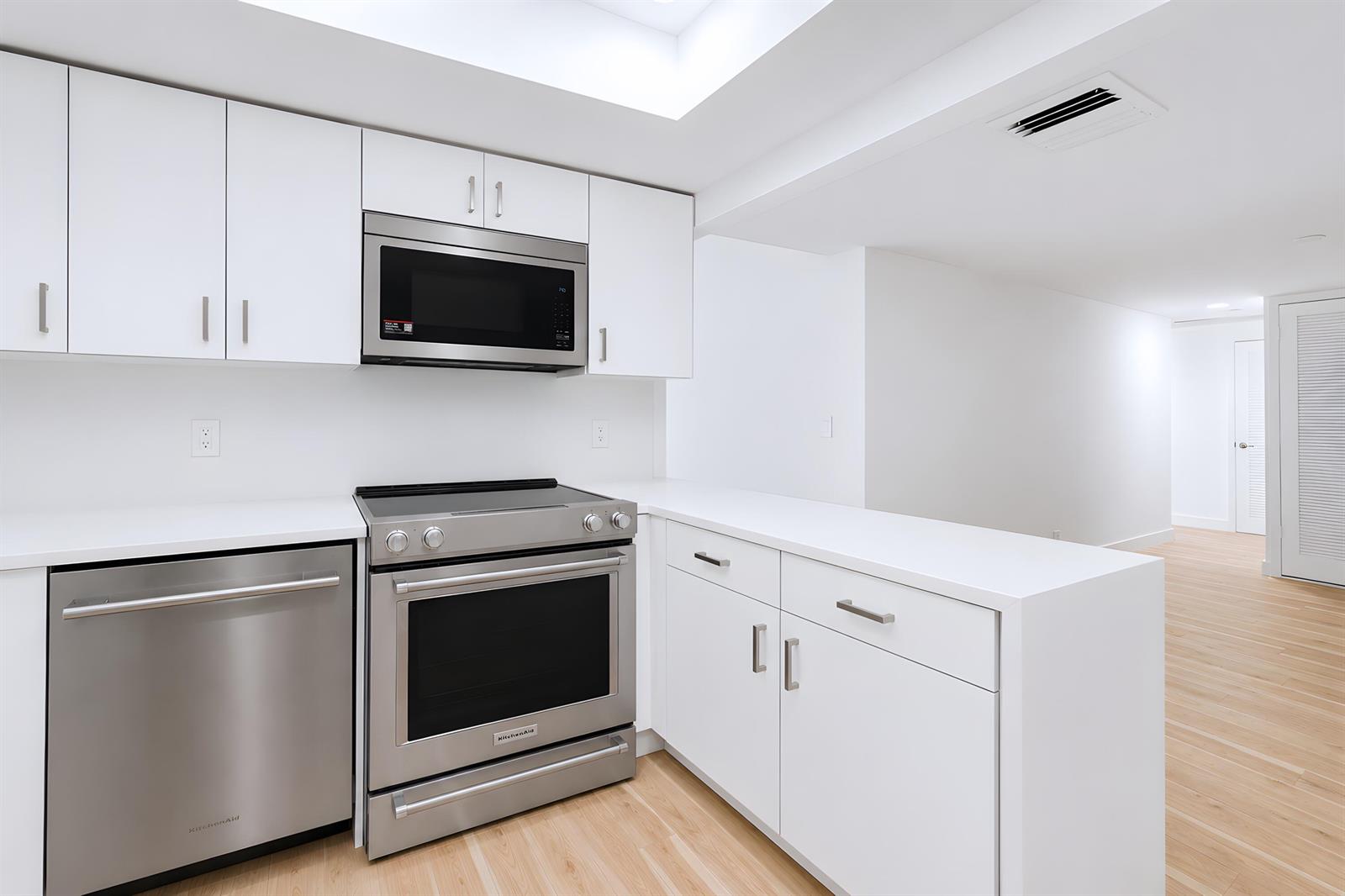An empty room with white walls, light wood flooring, and a window on the right — 3230 S Ocean Boulevard # 410, Palm Beach FL 33480, PALM BEACH, FL