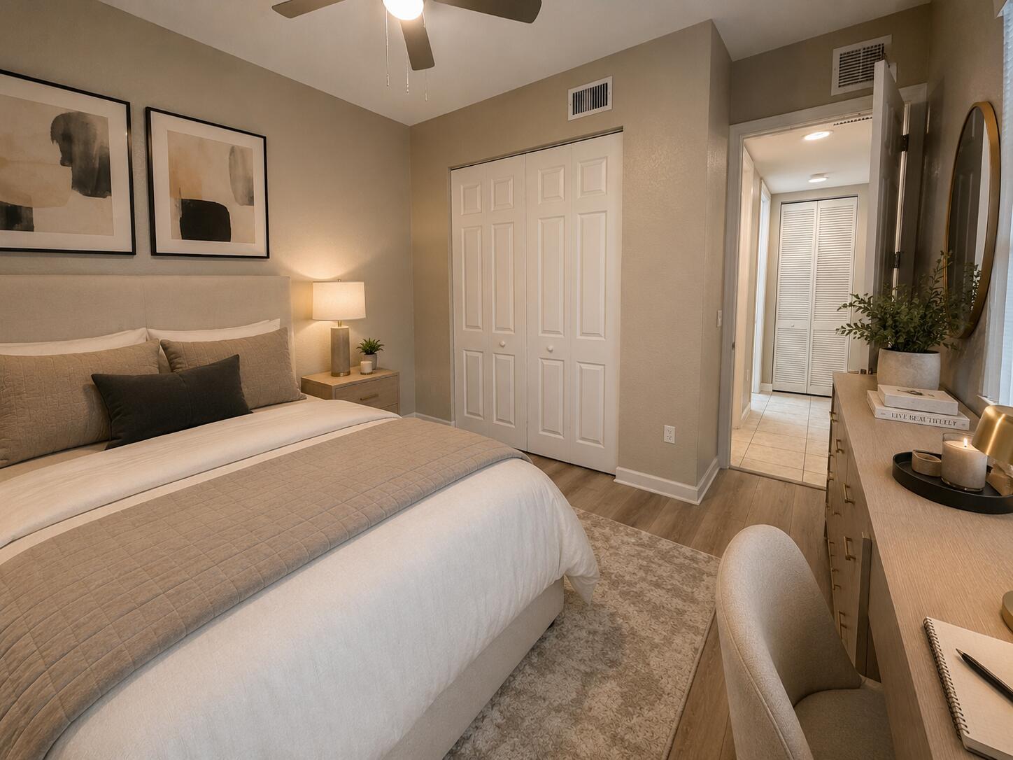 A bedroom with a bed, desk, and closet, featuring neutral decor and wood-look flooring — 7911 NW 128th Lane # c, Parkland FL 33076, PARKLAND, FL