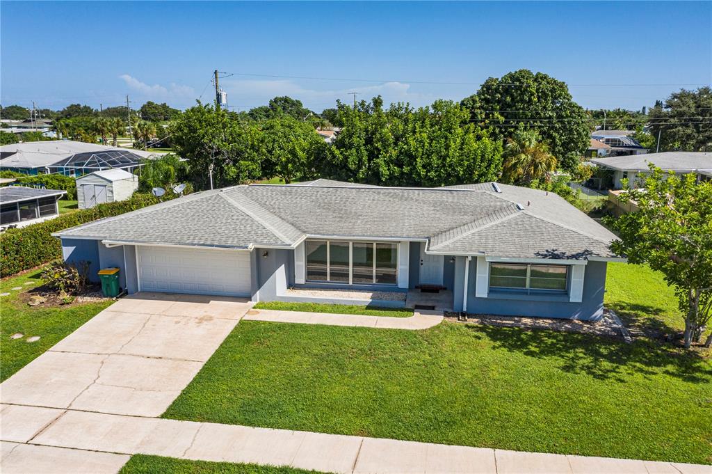 An aerial view of a single-story house with a gray roof and blue exterior walls — 326 WHERLEY AVENUE SE, PORT CHARLOTTE, FL