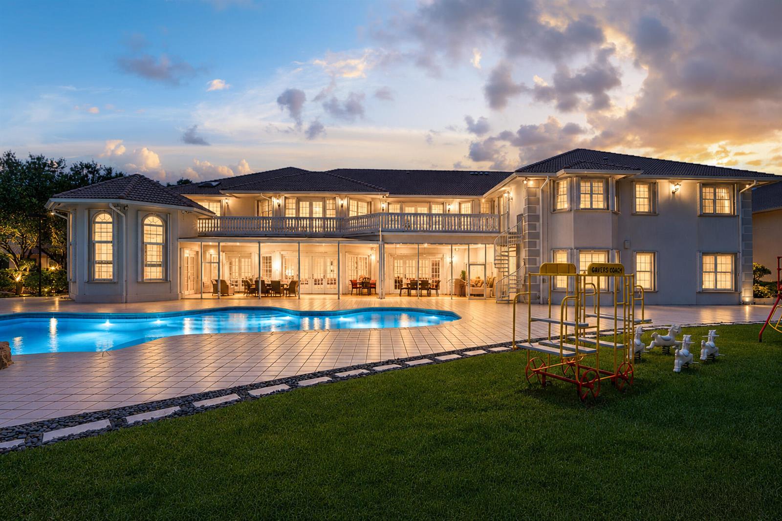 A large two-story house with a swimming pool, patio, and playground equipment on the lawn — 1800 Eagle Trace Boulevard, Coral Springs FL 33071, CORAL SPRINGS, FL