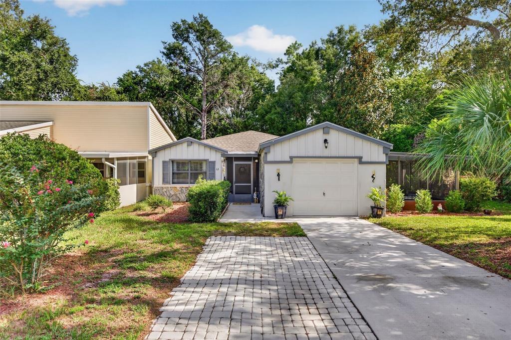 A single-story house with a garage, stone accents, and a paved driveway — 12 CHINABERRY CIRCLE, HOMOSASSA, FL