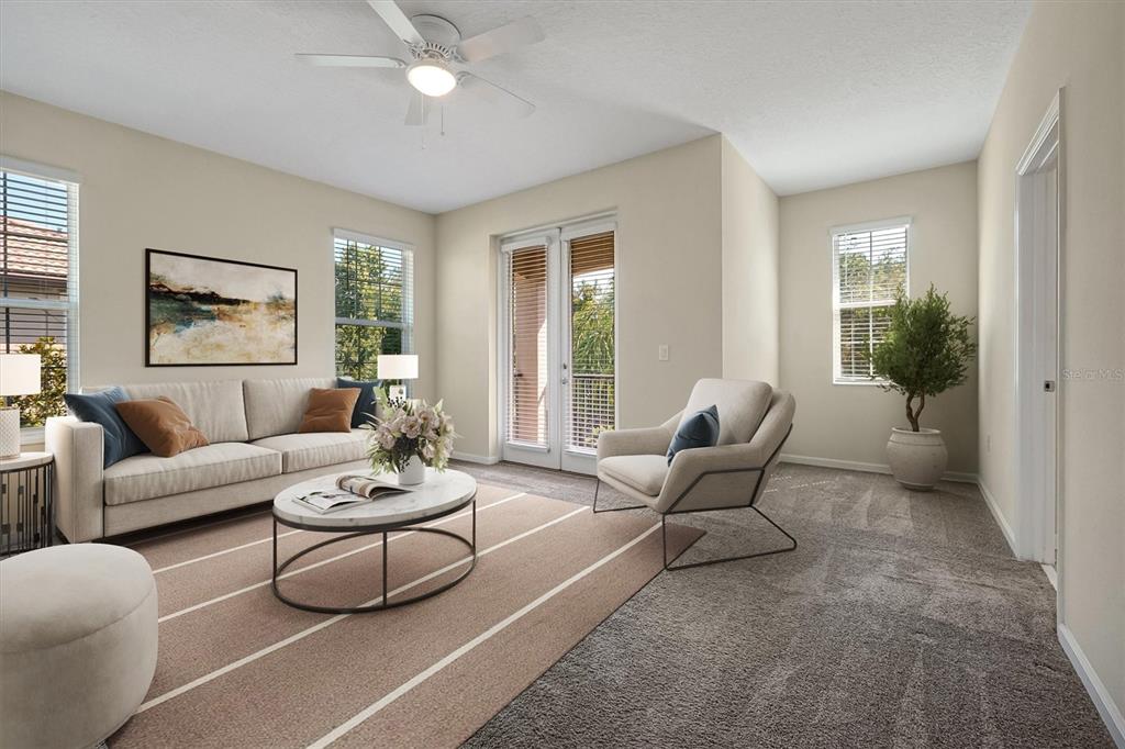 A living room features a sofa, an armchair, a coffee table, and glass balcony doors — 1383 SHINNECOCK HILLS DRIVE, DAVENPORT, FL