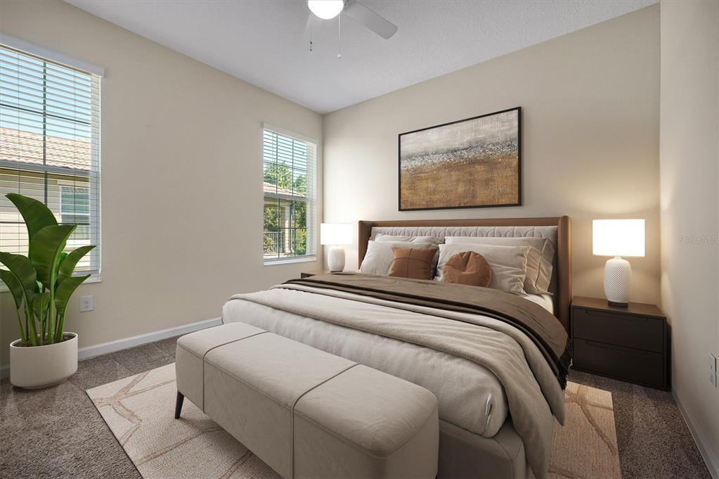 A bedroom features a king-sized bed, a bench, two nightstands, and two windows — 1383 SHINNECOCK HILLS DRIVE, DAVENPORT, FL