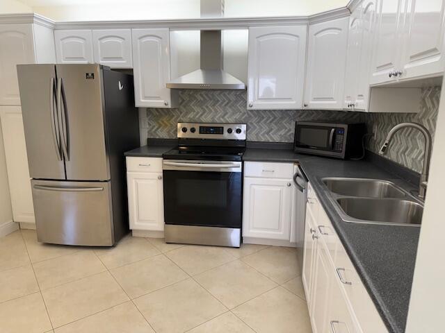 A kitchen features white cabinets, stainless steel appliances, a dark countertop, and a tiled backsplash — 9256 Sabal Ridge Circle # D, Boca Raton FL 33428, BOCA RATON, FL