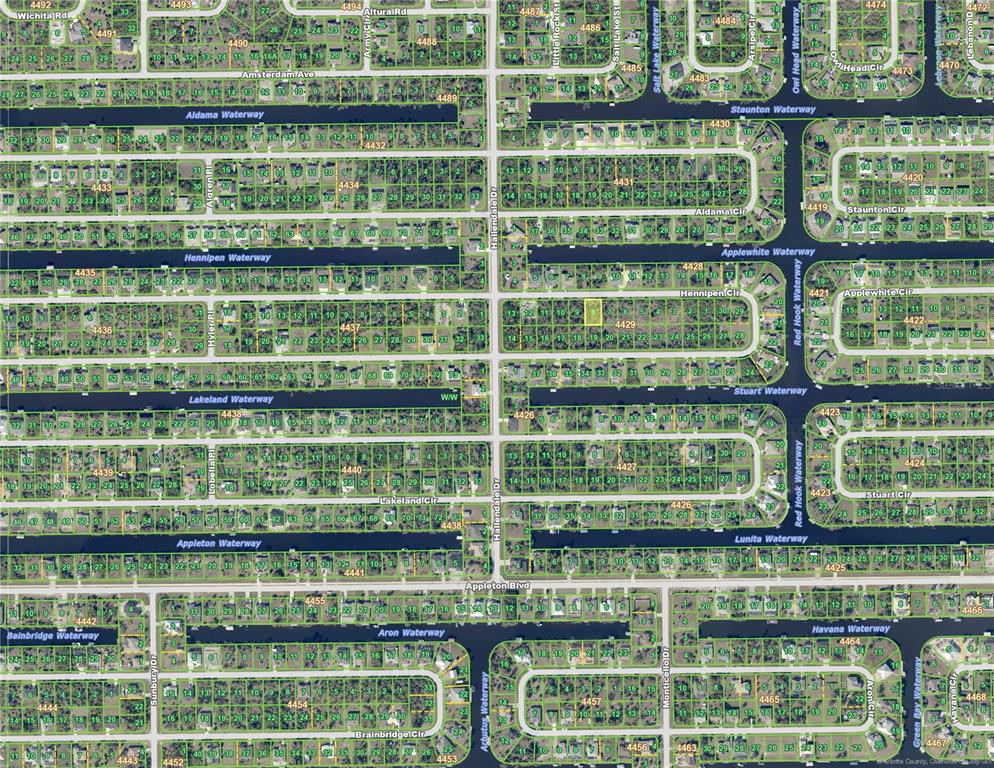 This is an aerial map showing residential lots, waterways, and streets in a neighborhood — 15809 HENNIPEN CIRCLE, PORT CHARLOTTE, FL