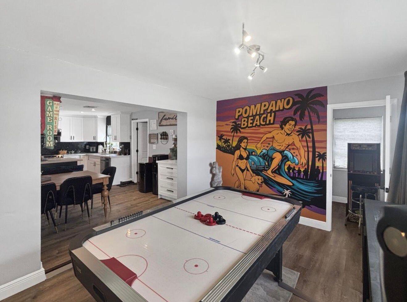 A game room features an air hockey table and a large Pompano Beach wall mural — 100 SW 17th Street, Pompano Beach FL 33060, POMPANO BEACH, FL