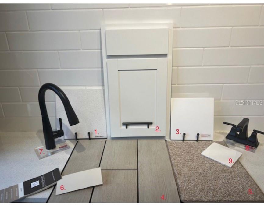 A display of interior design samples including cabinet doors, flooring, tile, and plumbing fixtures — 14514 BANKS COURT, PARRISH, FL