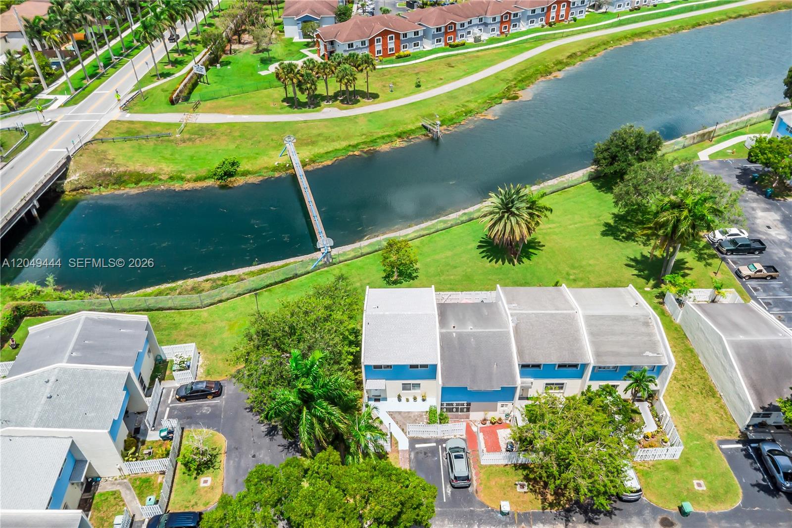 An aerial view shows a residential complex with a canal, a footbridge, and parking — 22334 SW 103rd Ct, Cutler Bay FL 33190, CUTLER BAY, FL