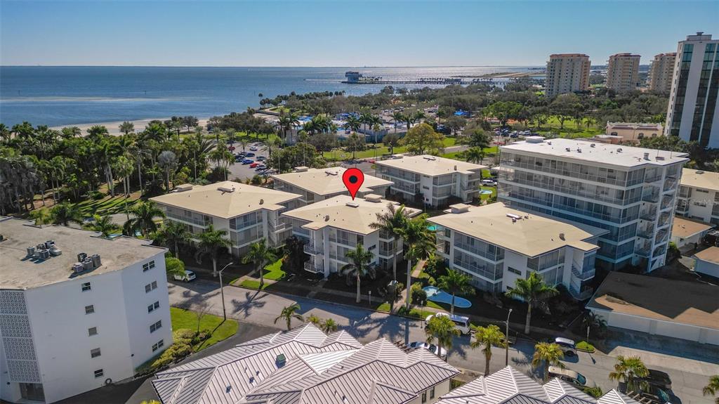 An aerial view shows several multi-story apartment buildings near a beach and the ocean — 1036 NORTH SHORE DRIVE NE UNIT 1, ST PETERSBURG, FL