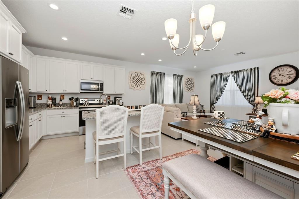 A two-story suburban house with light blue horizontal siding and white stucco exterior walls — 14075 LOCHEND WAY, WINTER GARDEN, FL