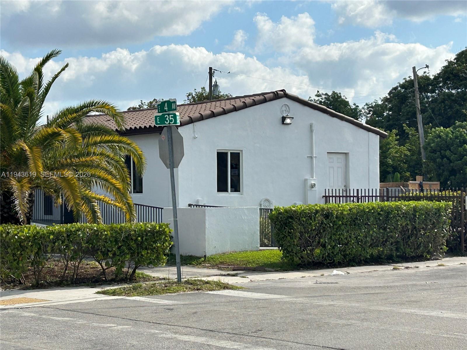 A white, single-story house with a brown tile roof sits on a corner lot — 3521 E 4th Ave, Hialeah FL 33013, HIALEAH, FL