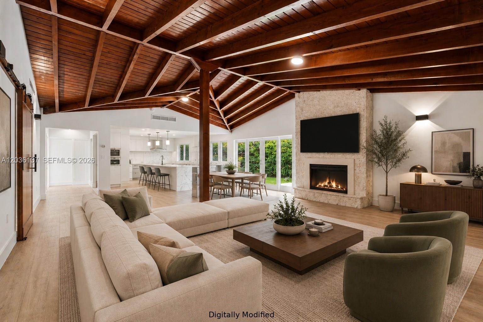 This digitally modified living room features a vaulted wood-beam ceiling, stone fireplace, and open layout — 1451 Urbino Ave, Coral Gables FL 33146, CORAL GABLES, FL