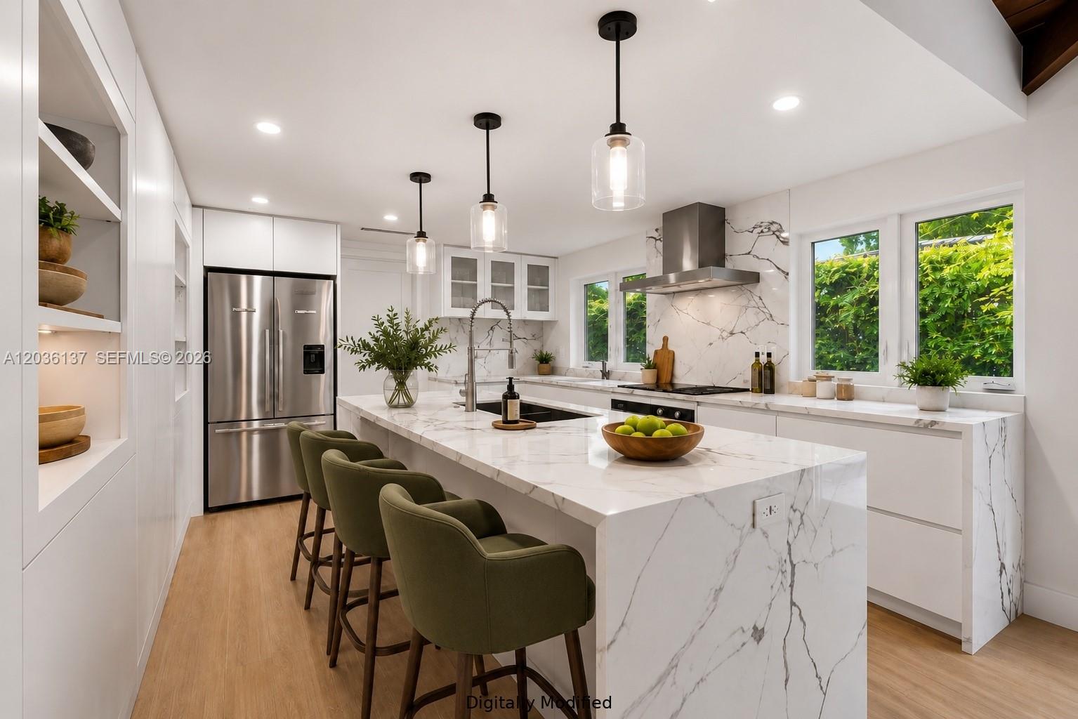 A modern kitchen features a large marble waterfall island, green bar stools, and stainless appliances — 1451 Urbino Ave, Coral Gables FL 33146, CORAL GABLES, FL