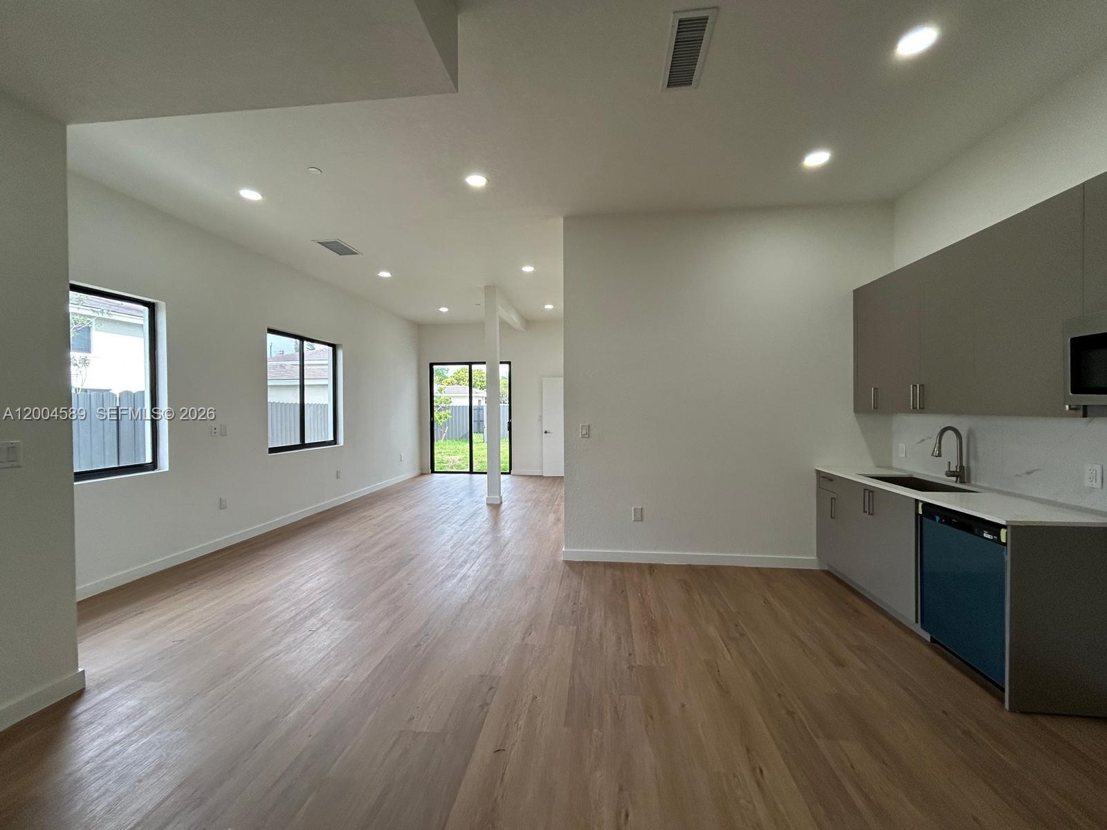 A two-story beige building features a paved parking lot with numbered spaces in front — 12552 SW 194th St # 0, Miami FL 33177, MIAMI, FL