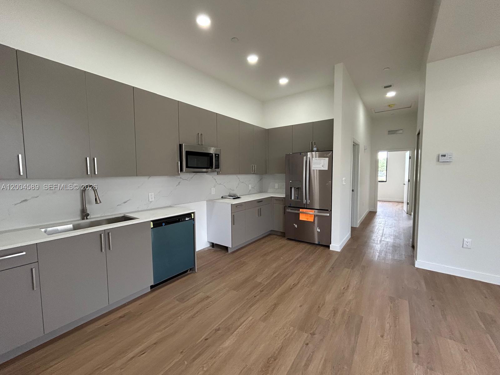 A beige two-story building features a paved parking space and a concrete walkway — 12552 SW 194th St # 0, Miami FL 33177, MIAMI, FL