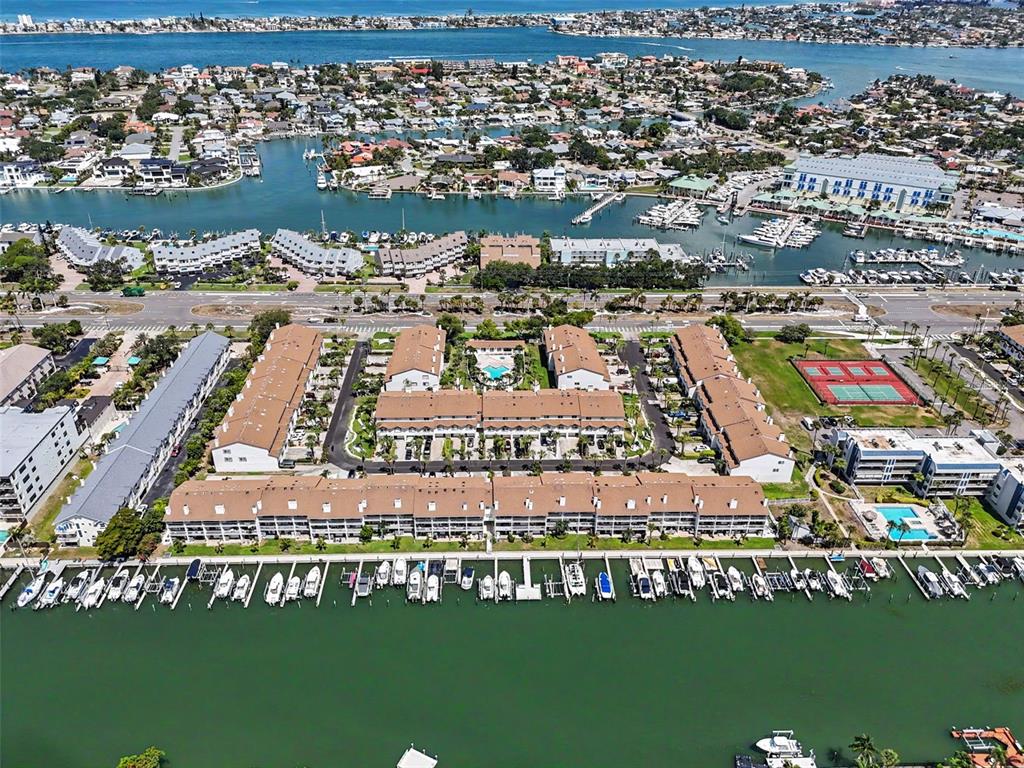 An aerial view of a waterfront condominium complex with boat slips and tennis courts — 269 MADEIRA CIRCLE, ST PETERSBURG, FL