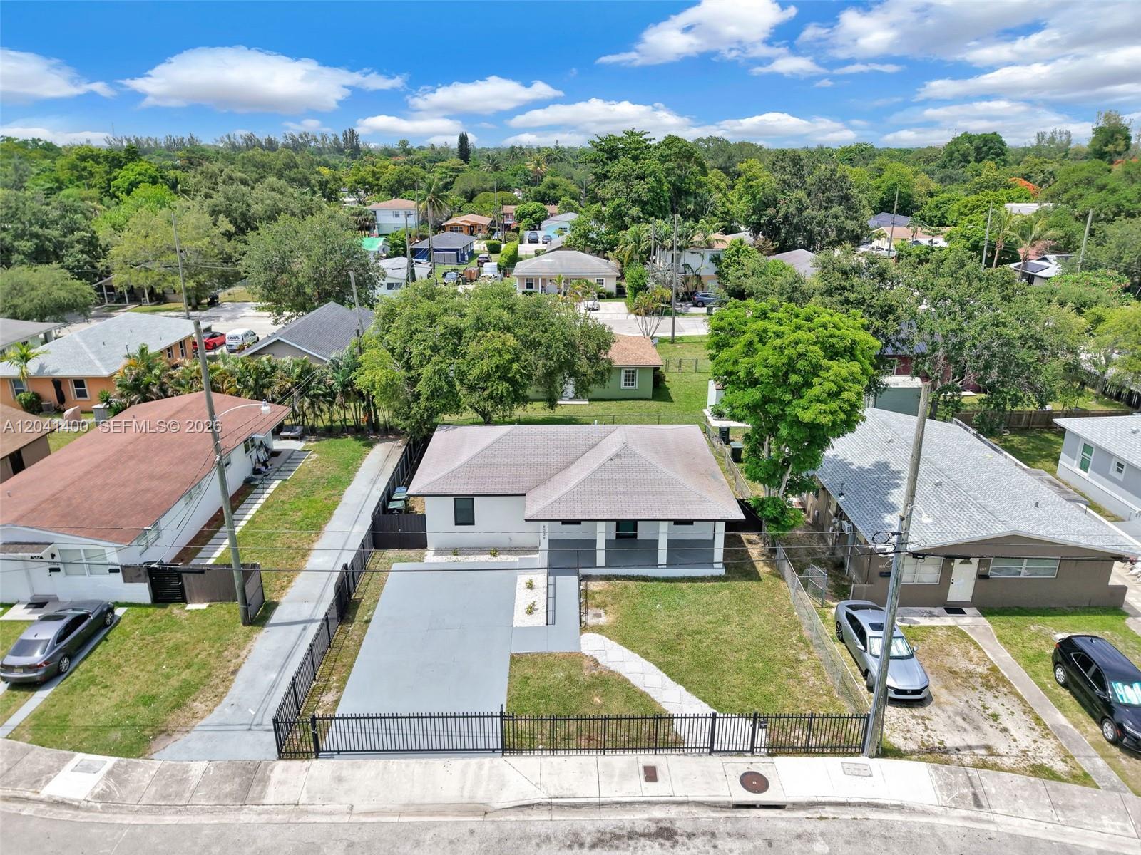 An aerial view shows a single-story house with a gray roof and a fenced yard — 6039 SW 63rd Ter, South Miami FL 33143, SOUTH MIAMI, FL