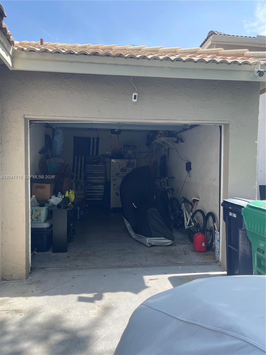 A paved walkway leads from a doorway toward a street lined with trees and hedges — 11491 SW 72nd Ter, Miami FL 33173, MIAMI, FL