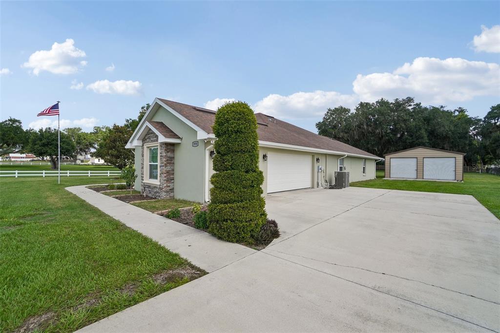 A single-story house with a stone-accented facade, a two-car garage, and a detached shed — 3934 CONNERSVILLE ROAD, BARTOW, FL