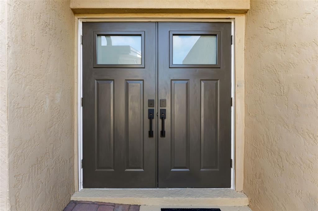 A set of dark brown double front doors with glass panels set in a stucco wall — 105 E DAVIS BOULEVARD UNIT B, TAMPA, FL