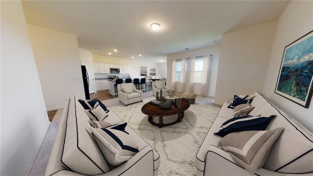 This is a rendering of an open-concept living room and kitchen with neutral decor — 10862 CURVING CREEK LOOP, PARRISH, FL