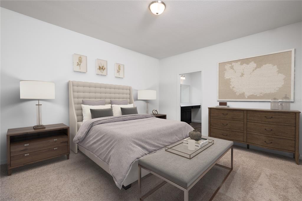A bedroom with a tufted headboard, wooden furniture, and a bench at the foot — 10862 CURVING CREEK LOOP, PARRISH, FL
