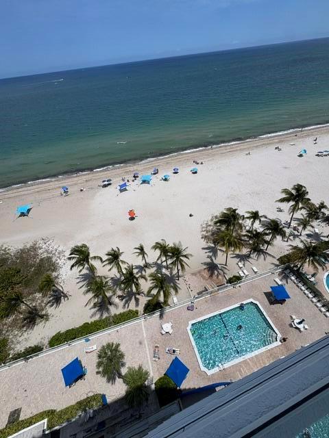 An elevated view shows a swimming pool, palm trees, and a sandy beach by the ocean — 1000 S Ocean Boulevard # 14a, Pompano Beach FL 33062, POMPANO BEACH, FL