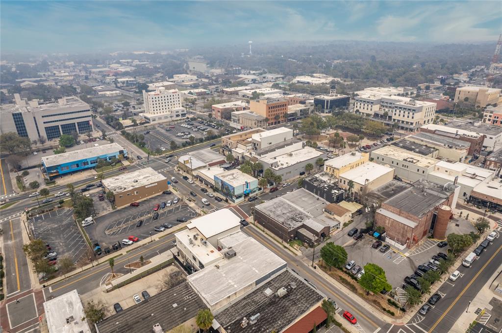 An aerial view of a city downtown area featuring various commercial buildings, parking lots, and streets — 40 SW 1ST STREET, OCALA, FL