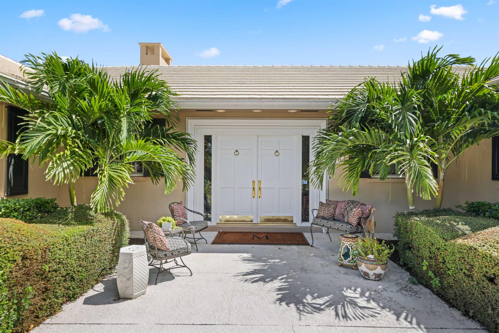 The exterior of a house features a white double door entrance flanked by two palm trees — 36 Country Road, FL 33436, FL